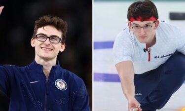 USA gymnast Stephen Nedoroscik waves to the crowd while curler Aidan Oldenburg competes at the 2026 Olympics