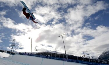 Snowboarder performs a trick in the halfpipe
