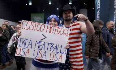 Fans at the Milan Cortina Olympics show off a custom sign