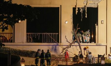 Firemen and rescue workers inspect the site of an explosion at the Fairmont The Palm Hotel in Dubai