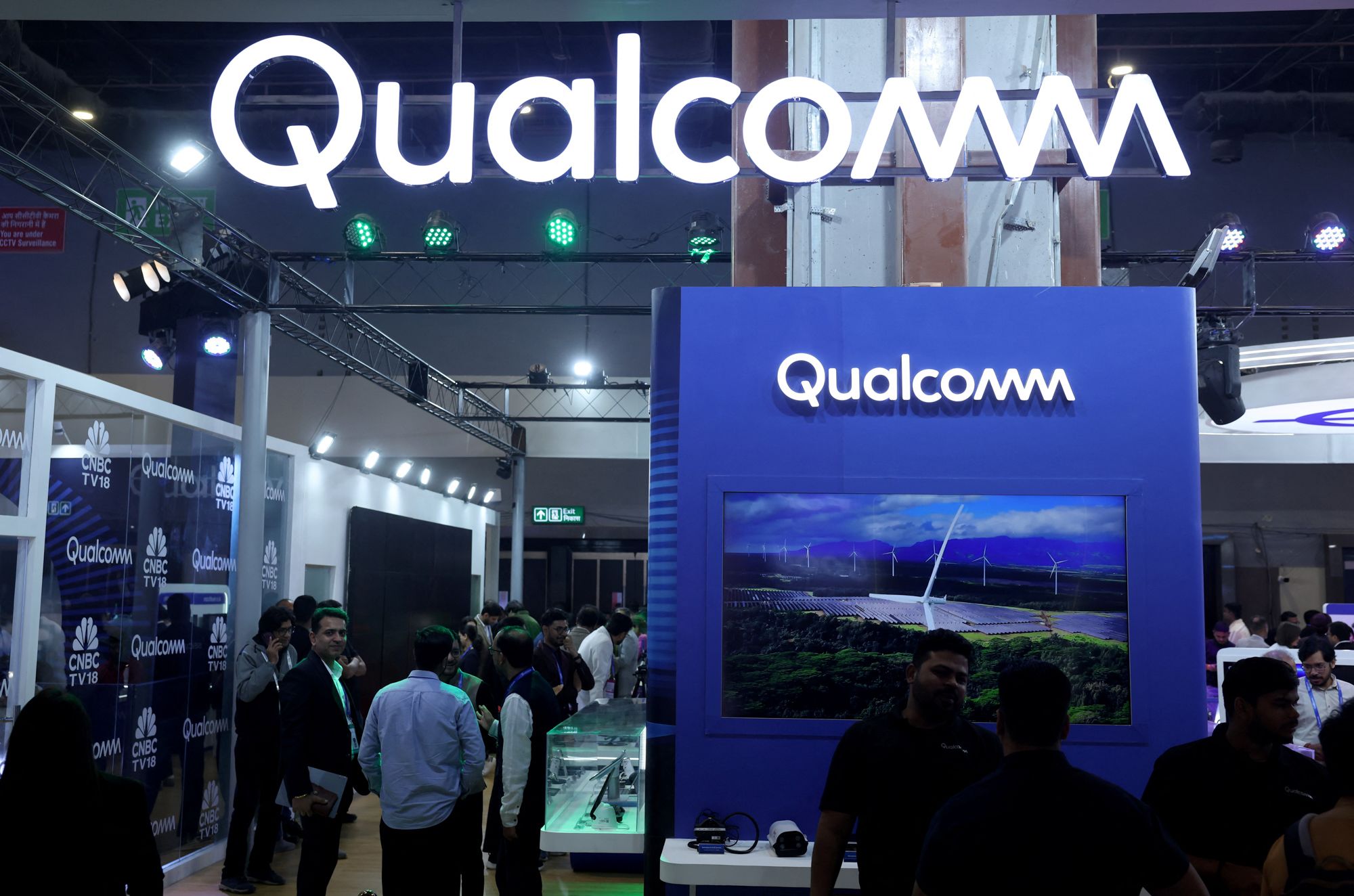 <i>Bhawika Chhabra/Reuters via CNN Newsource</i><br/>Visitors stand at the Qualcomm kiosk at Bharat Mandapam