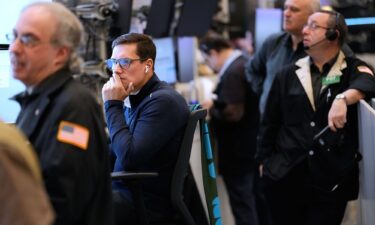 A police vehicle and an ambulance are parked on the departure road of Dubai International Airport as it lies deserted following its closure in Dubai