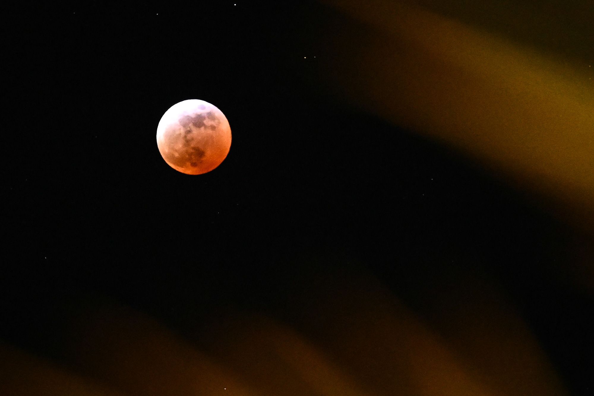 <i>Juan Barreto/AFP/Getty Images via CNN Newsource</i><br/>People gather near a telescope to watch the full blood moon in Caracas