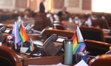 Siobhan Kirchstein stands at a Kansas DMV counter where she surrendered her driver's license on Thursday