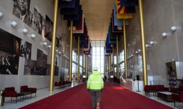 A worker walks through the Hall of States at the John F. Kennedy Memorial Center for the Performing Arts