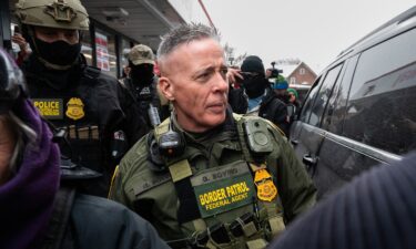 US Border Patrol commander Gregory Bovino walks to his vehicle at a gas station in Minneapolis