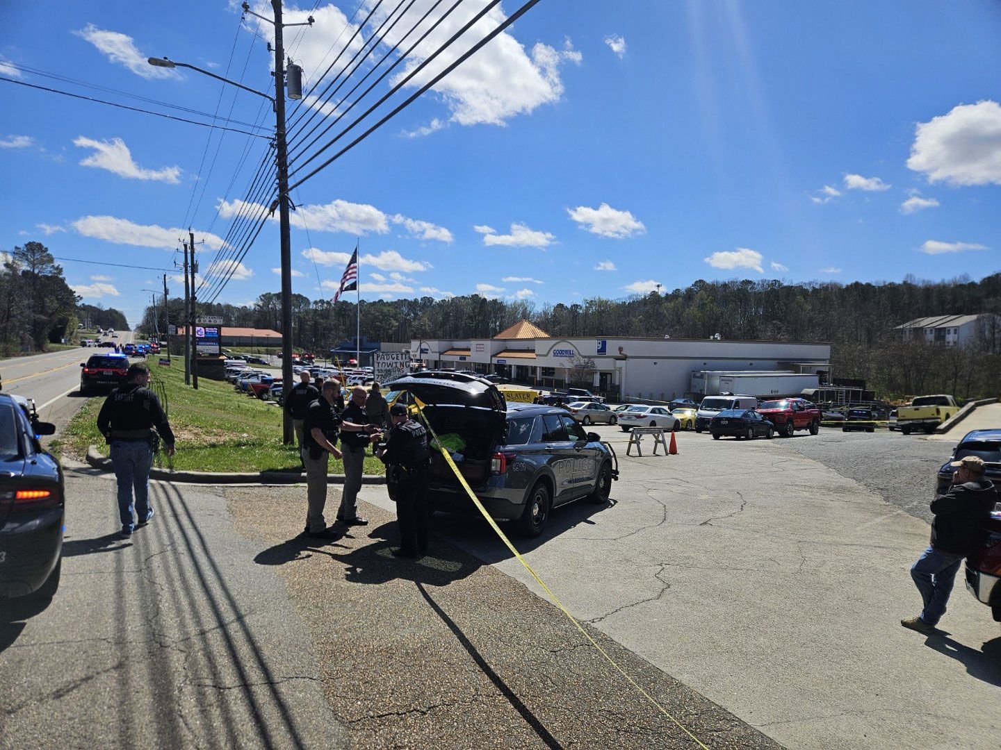 <i>Pickens Progress via CNN Newsource</i><br/>The shopping center where a Veterans Affairs employee was shot Tuesday is cordoned off by yellow tape and law enforcement vehicles.
