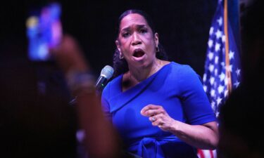 Attendees react to incoming results during a primary election night event with Juliana Stratton