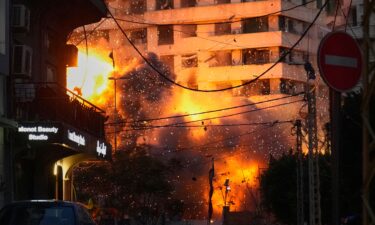 An explosion erupts from a building following an Israeli strike in central Beirut