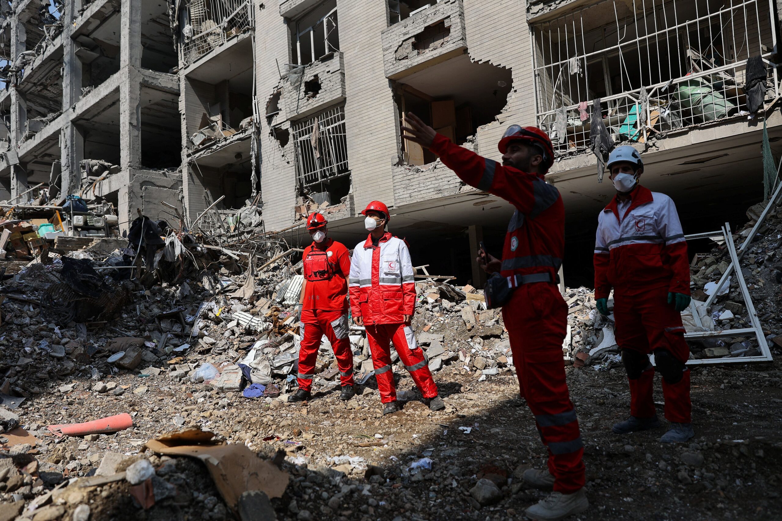 <i>Majid Asgaripour/Wana News Agency/Reuters via CNN Newsource</i><br/>Members of a Red Crescent rescue team work at a building that was damaged by a strike
