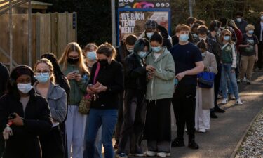 People queue to receive vaccinations on the University of Kent campus