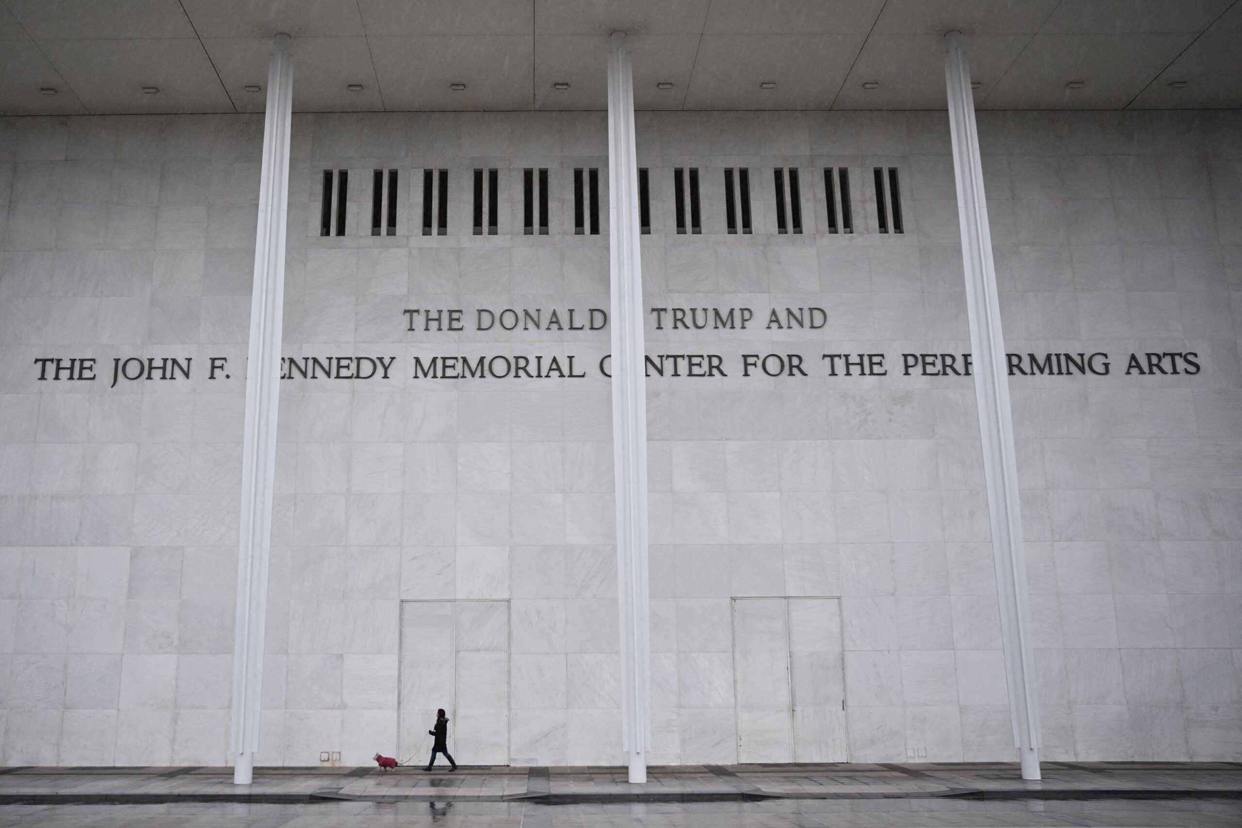 <i>Mandel Ngan/AFP/Getty Images via CNN Newsource</i><br/>A person and a dog walk in front of the Kennedy Center in Washington
