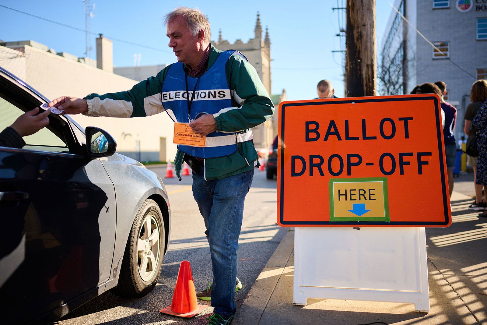 <i>Dustin Franz/AFP/Getty Images via CNN Newsource</i><br/>An official ballot collector for the Cuyahoga County Board of Elections gives a voter their 