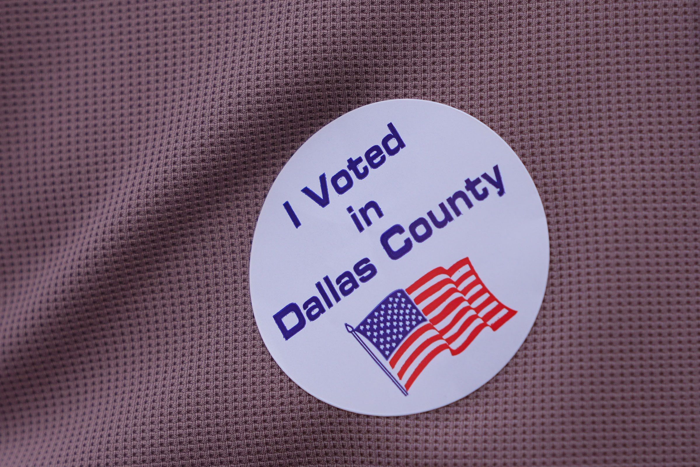 <i>LM Otero/AP via CNN Newsource</i><br/>A primary voter wears a sticker after casting a ballot at a voting center in Dallas