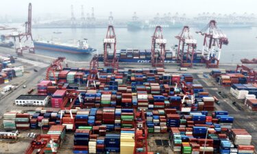 Cargo containers and ships are seen at a port in Qingdao