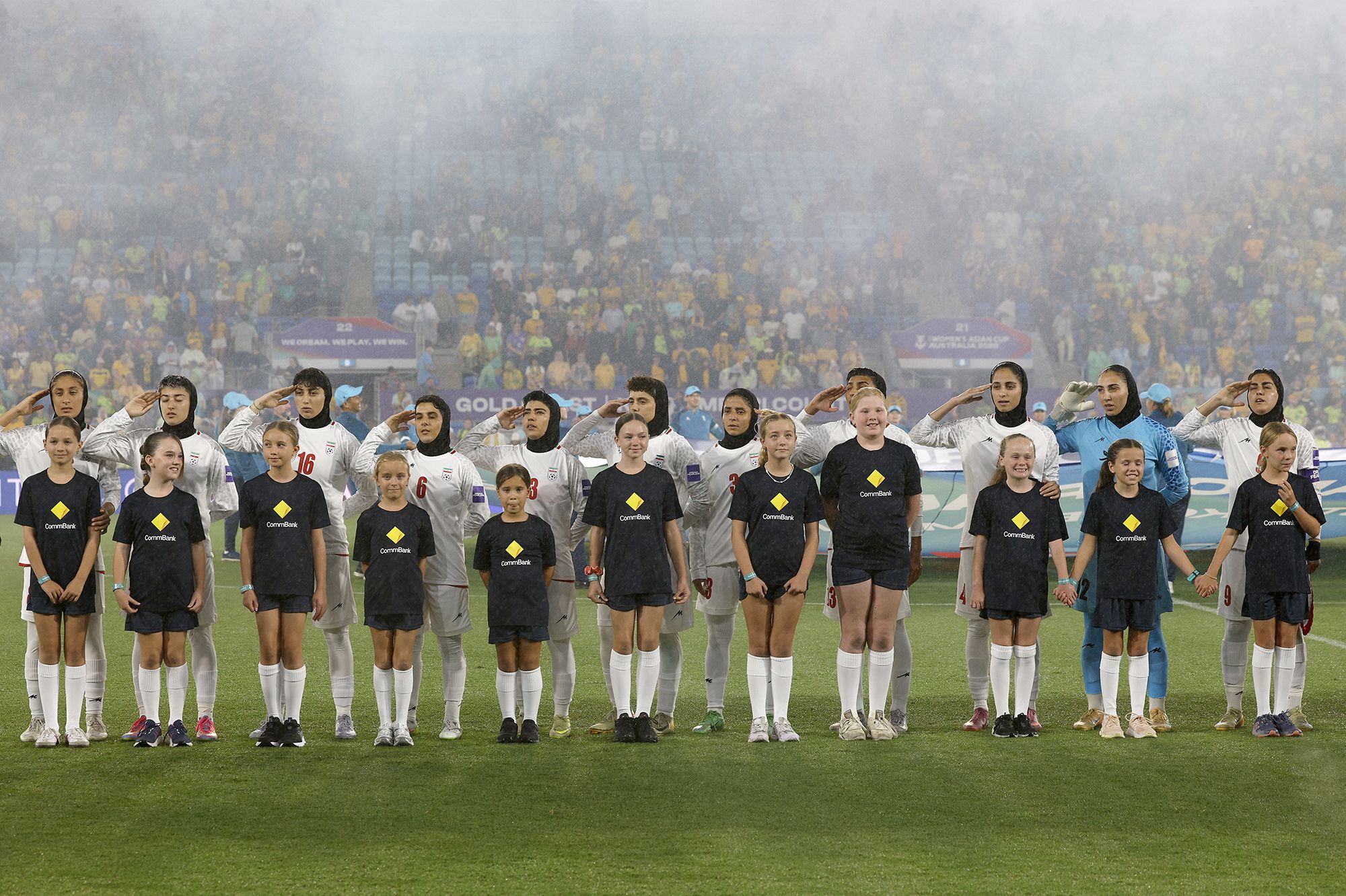 <i>Izhar Khan/AFP/Getty Images via CNN Newsource</i><br/>Iran's players salute and sing the national anthem before a group stage match against Australia at the 2026 AFC Women's Asian Cup in the Gold Coast on March 5.