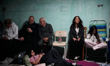 People inspect destruction at the site of an Israeli airstrike that targeted Mar Mikhael neighborhood in the southern suburbs of Beirut