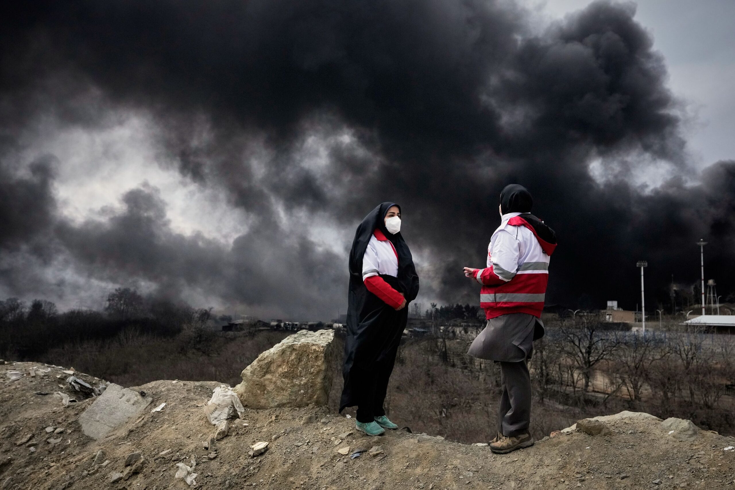 <i>Vahid Salemi/AP via CNN Newsource</i><br/>A thick plume of smoke from a strike on an oil storage facility late Saturday lingers in the cloudy sky over Tehran