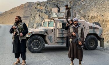 Taliban security personnel stand guard near the Torkham border crossing between Afghanistan and Pakistan in the Nangarhar province