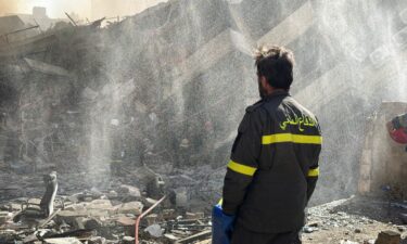 A displaced woman and her daughter sit outside a tent following an escalation between Hezbollah and Israel