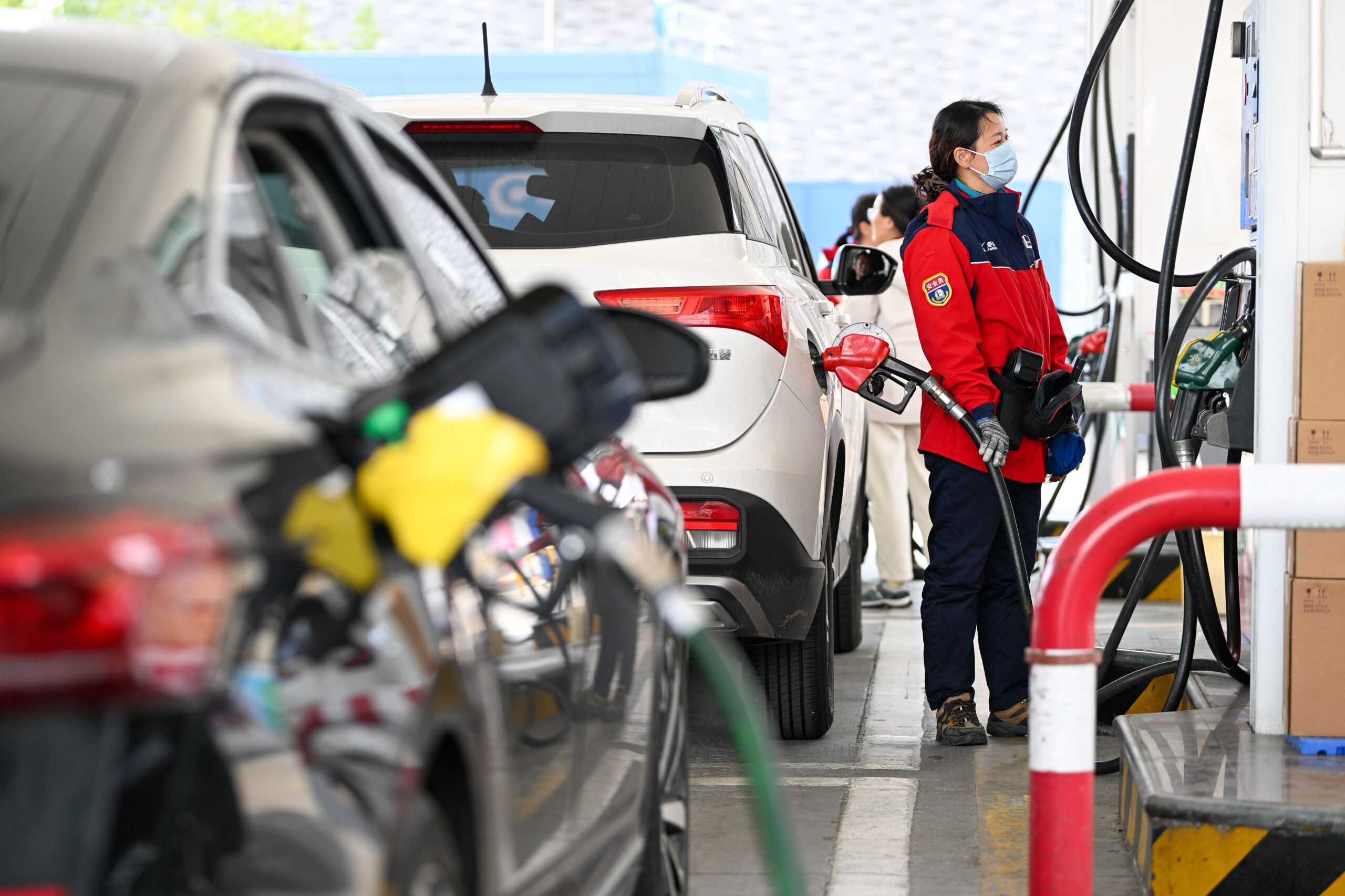 <i>Fang Dongxu/FeatureChina/AP via CNN Newsource</i><br/>A worker refills a car at a gas station in Nanjing in eastern China on March 9