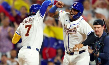 Members of Team Venezuela stand during the national anthem before their game in Miami on Friday.