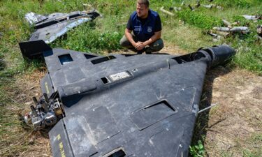 Dmytro Chubenko of the Kharkiv regional prosecutor's office examines the carbon fiber remains of a Russian-made