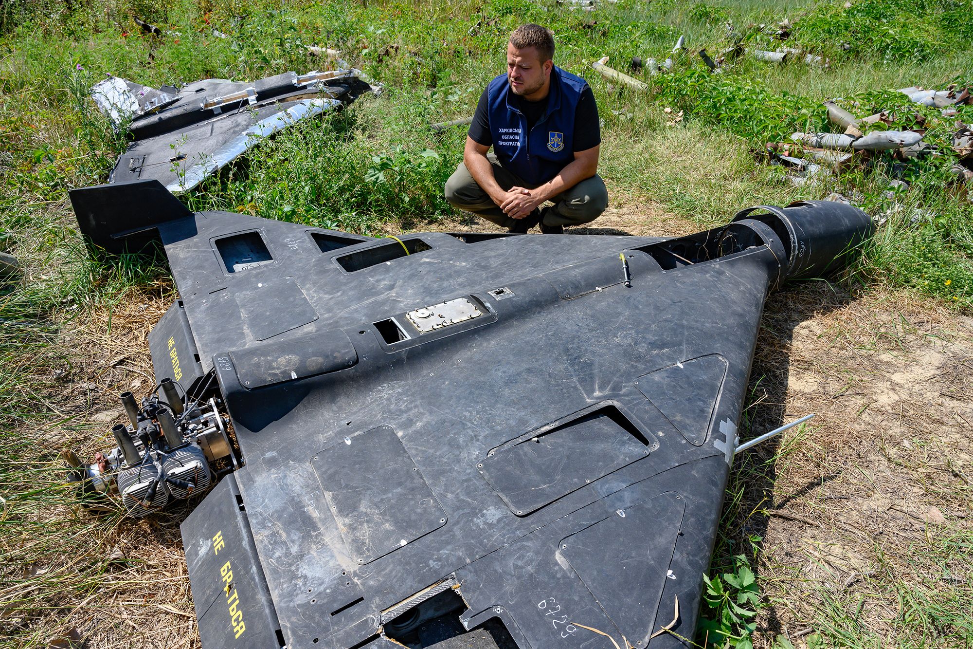 <i>Scott Peterson/Getty Images via CNN Newsource</i><br/>Dmytro Chubenko of the Kharkiv regional prosecutor's office examines the carbon fiber remains of a Russian-made
