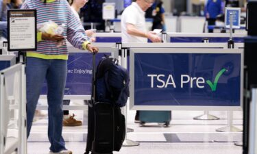 Travelers wait in line to get into a Transportation Security Administration checkpoint at William P. Hobby Airport in Houston