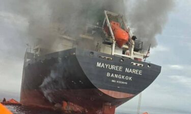 A resident walks in front of a building damaged by an Israeli strike in central Beirut