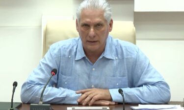 People stand on the street during a mass blackout in Havana
