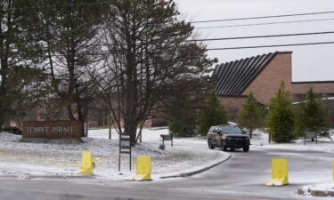 Families leave after being reunited outside Temple Israel synagogue after an assailant rammed his truck into the building in West Bloomfield