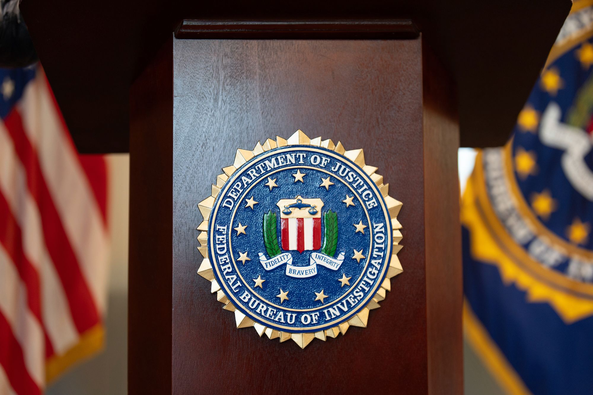 <i>Jenny Kane/AP via CNN Newsource</i><br/>An FBI seal is displayed on a podium before a news conference at the field office in Portland