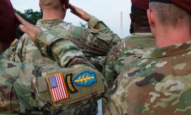 Army paratroopers from the 82nd Airborne Division conduct a reenlistment ceremony near the Reflecting Pool in Washington