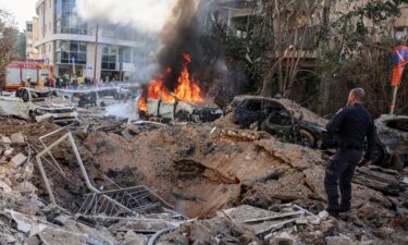 Emergency personnel respond at a site following Iranian missile barrages in central Israel