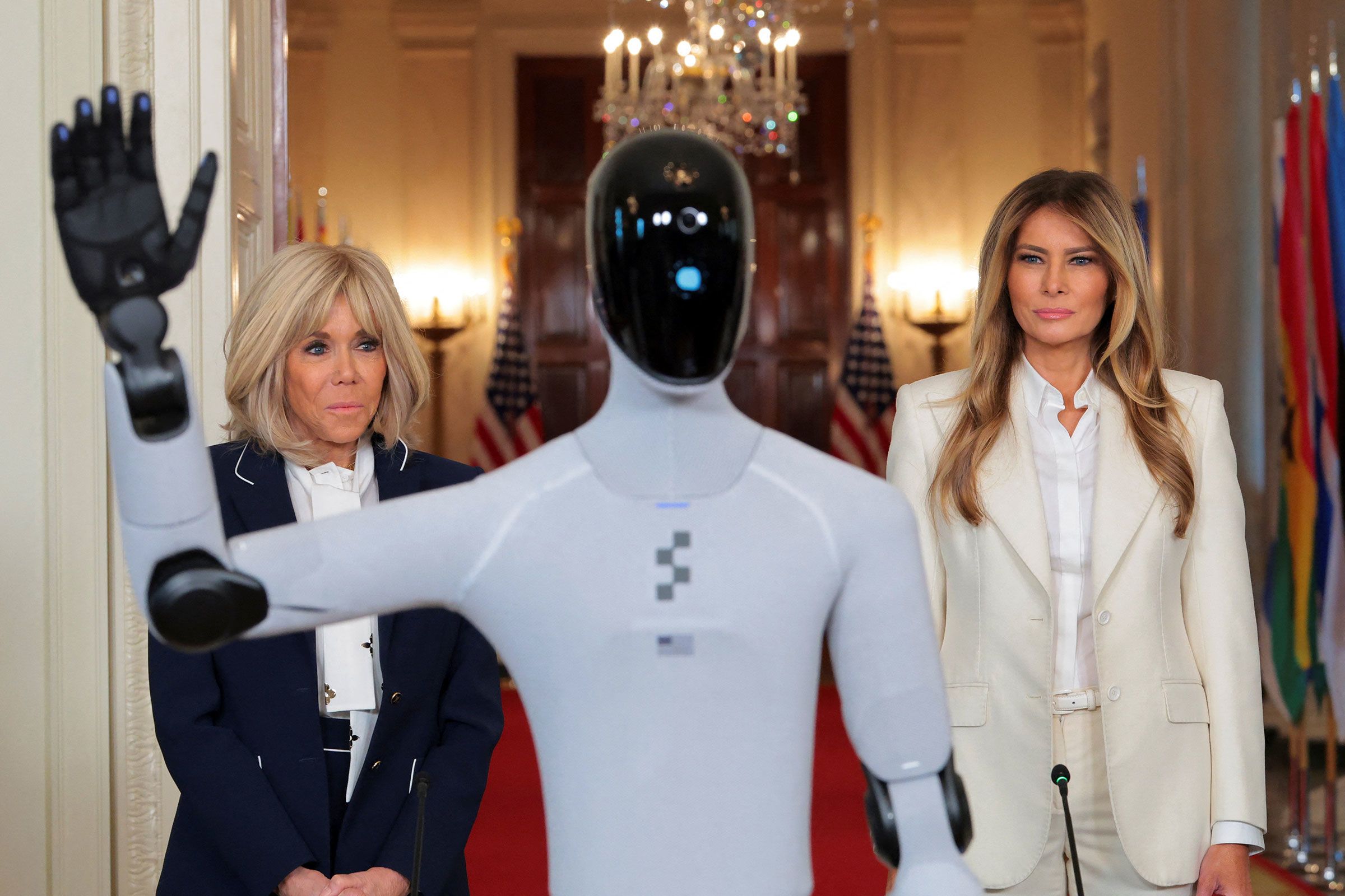 <i>Kylie Cooper/Reuters via CNN Newsource</i><br/>US first lady Melania Trump and French first lady Brigitte Macron look at a humanoid robot