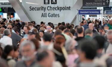 Travelers wait in line at Hartsfield-Jackson Atlanta International Airport on March 25