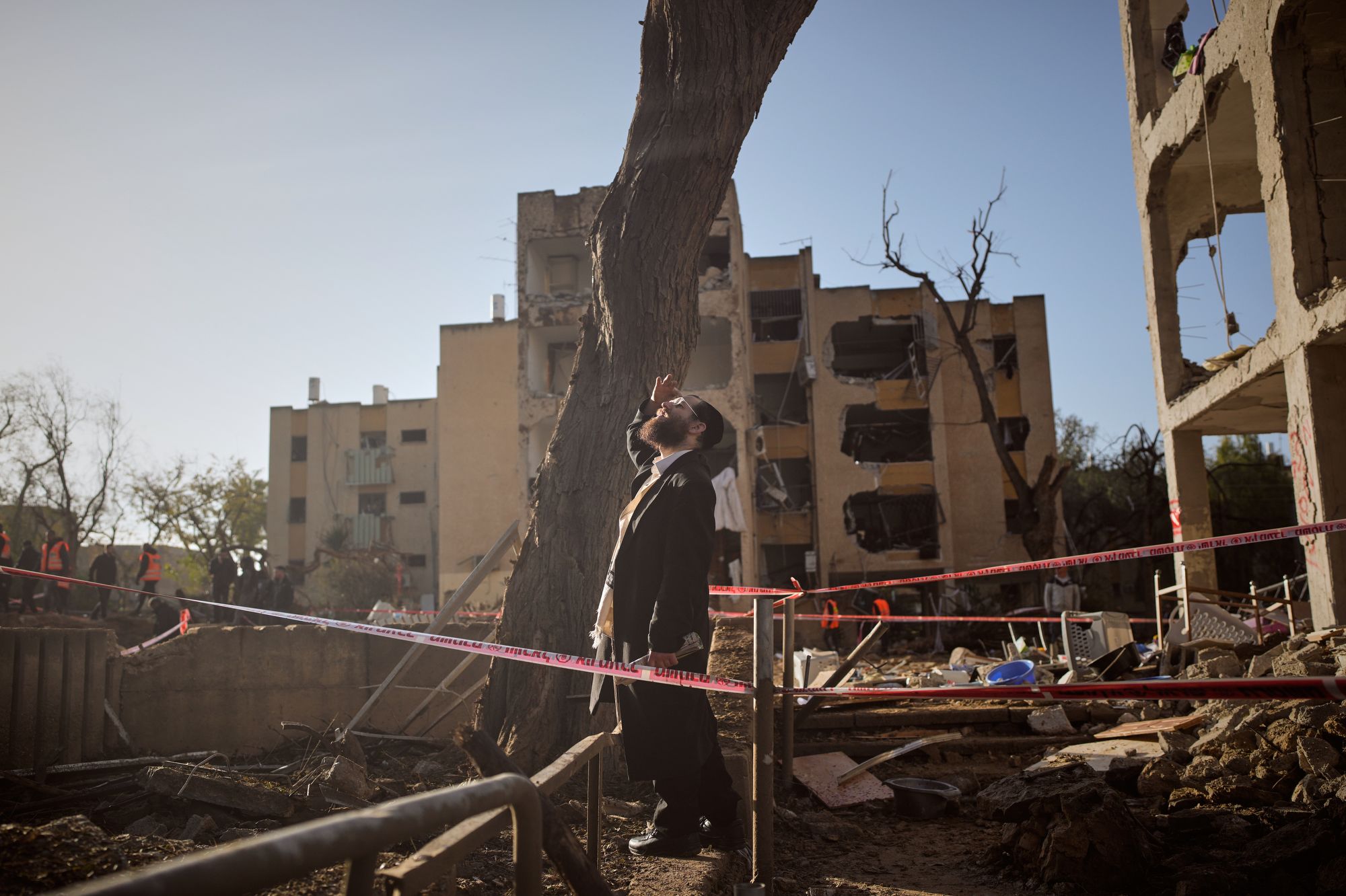 <i>Ohad Zwigenberg/AP via CNN Newsource</i><br/>A man looks at residential buildings damaged by an Iranian missile strike in Arad