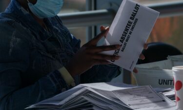 A banner of President Trump hangs from the Department of Justice building in Washington