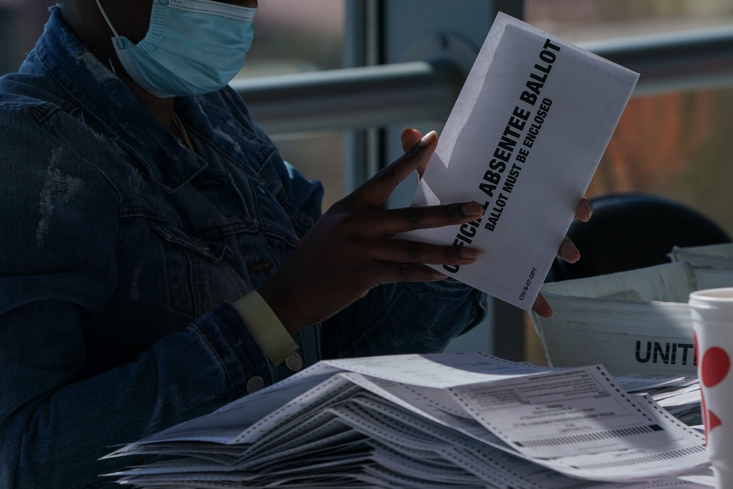 <i>Annabelle Gordon/Sipa USA/AP/File via CNN Newsource</i><br/>A banner of President Trump hangs from the Department of Justice building in Washington