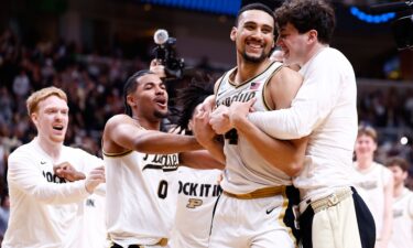 Arizona forward Koa Peat dunks the ball during the first half against Arkansas.