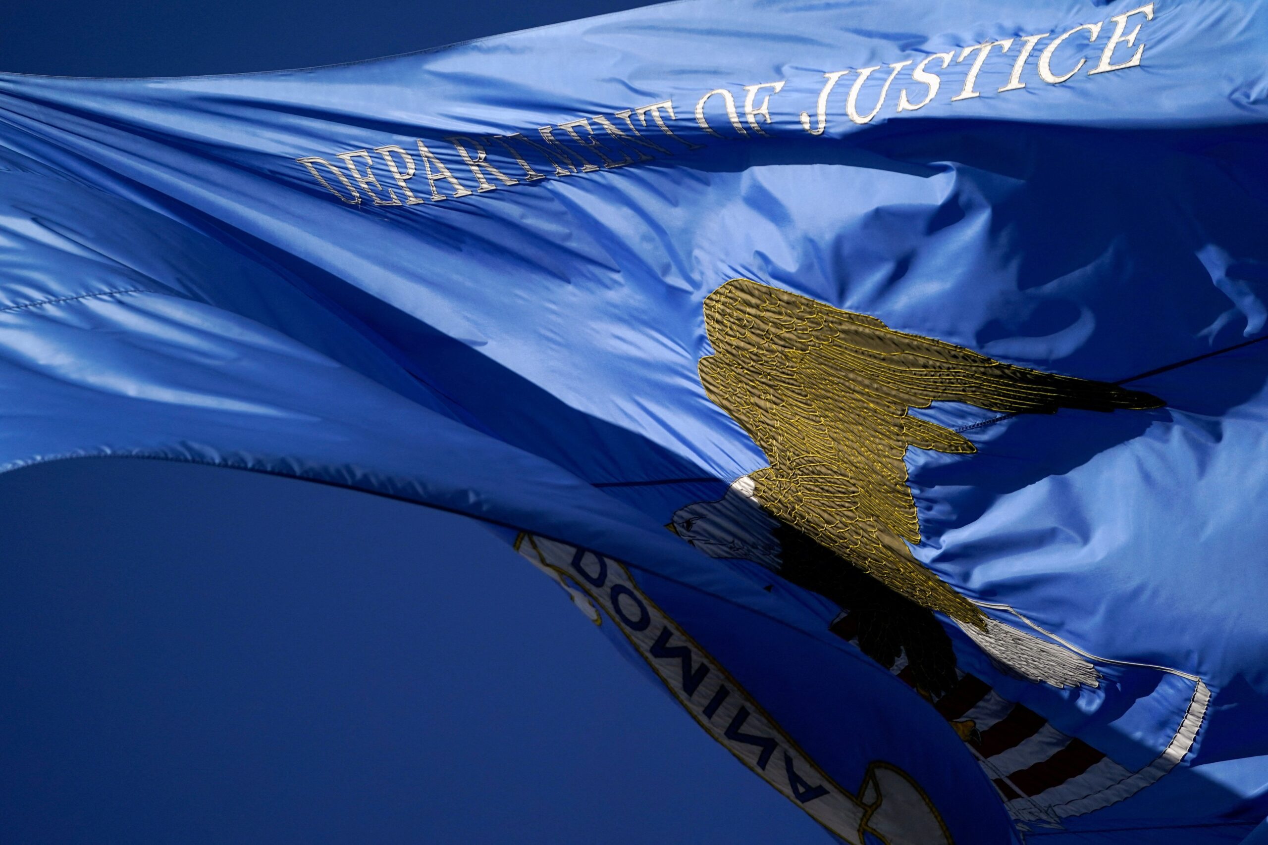 <i>Nathan Howard/Reuters via CNN Newsource</i><br/>A flag flutters outside the Department of Justice building in Washington