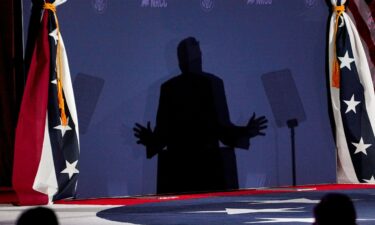President Donald Trump is silhouetted during the National Republican Congressional Committee annual fundraising dinner in Washington