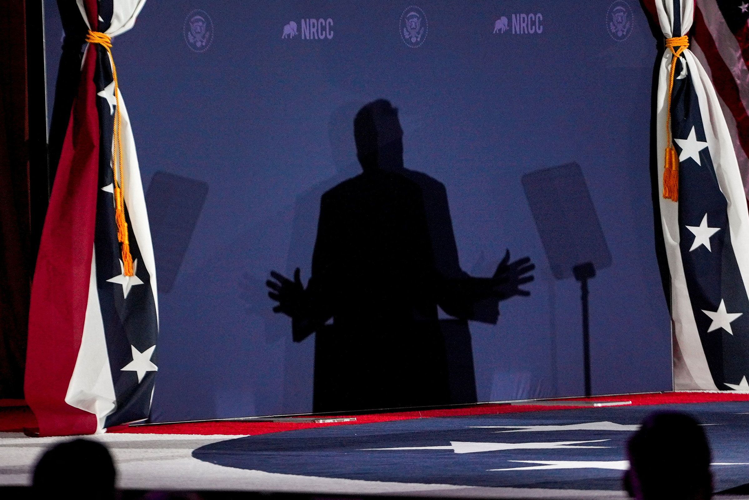 <i>Ken Cedeno/Reuters via CNN Newsource</i><br/>President Donald Trump is silhouetted during the National Republican Congressional Committee annual fundraising dinner in Washington