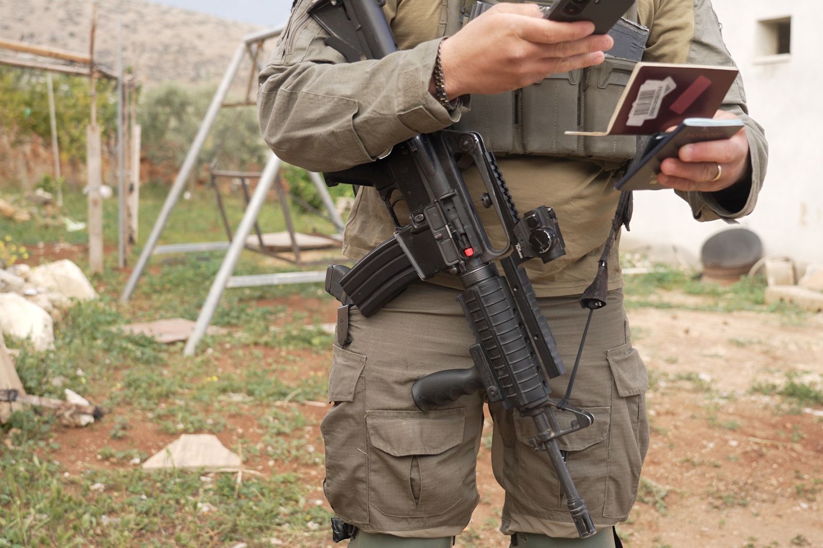 <i>Cyril Theophilos/CNN via CNN Newsource</i><br/>An israeli soldier's gun is seen as soldiers detain CNN crew members.