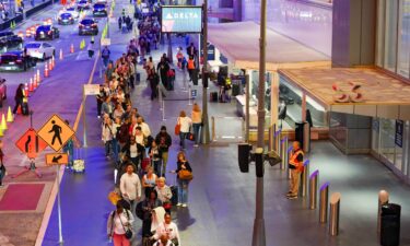 Travelers wait in long lines early in the morning at Atlanta Hartsfield-Jackson International Airport on March 27 in Atlanta.