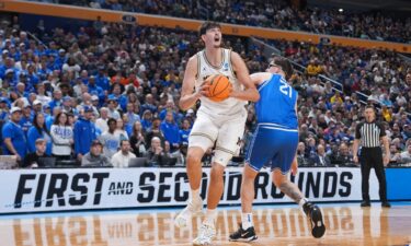 Saint Louis Billikens guard Amari McCottry shoots while defended by Michigan Wolverines center Aday Mara in the first half Saturday.