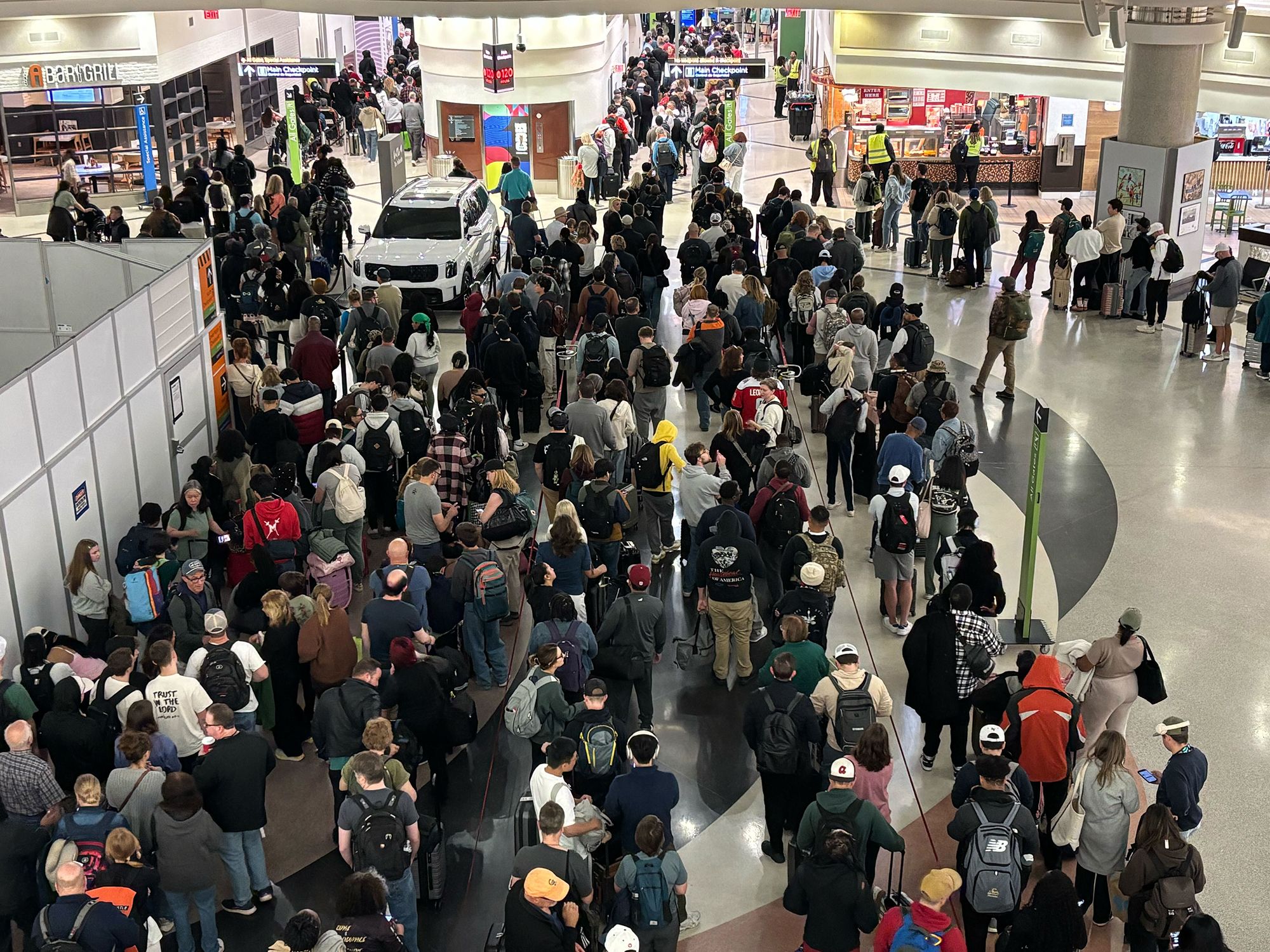 <i>Phelan M. Ebenhack/AP via CNN Newsource</i><br/>Travelers wait for their flights at a JetBlue Airways gate at Orlando International Airport