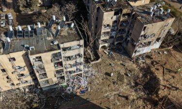 A drone view shows a crater in a residential neighbourhood