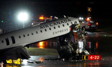 Debris hangs from a damaged Air Canada jet that collided with a fire truck while landing Monday night at New York's LaGuardia Airport.